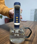 All In One 5 In 1 Water Quality Tester Handheld Digital Meter For pH TDS EC Salinity And Temperature in a glass of water