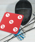 Sturdy Indoor Hanging Fencing Practice Target with dope double sided rubber surface next to fencing gear