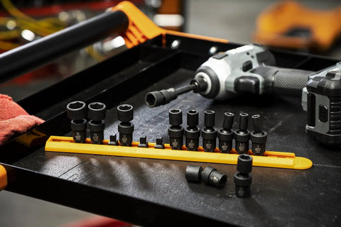 12 Piece 1 Quarter Inch Drive 6 Point Universal Impact Socket Set Metric displayed on a tray with tools in background