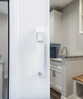 Close-up of white push-button latch on Corrosion Resistant Screen Door Hardware Kit With Pneumatic Closer And Push Button Latch For Out Swinging Doors No Lockout Feature Includes Hold Open Washer And Jamb Bracket White.
