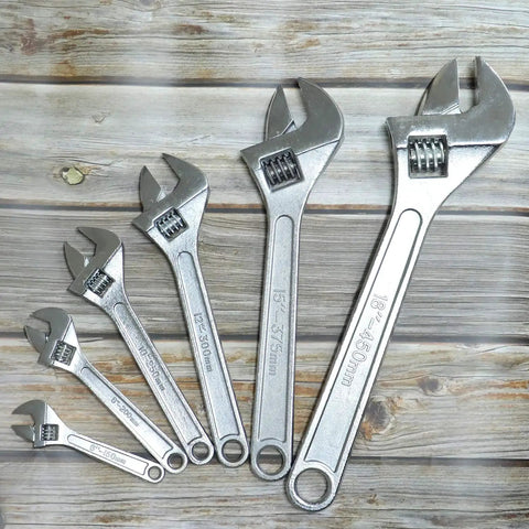 15 Inch Adjustable Wrench With 45mm Jaw Opening For Heavy Duty Garage And DIY Projects, shown with other sizes against wood