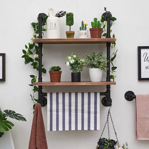 Industrial Pipe Shelves With Towel Bar For Bathroom holding plants and decor, rustic wood planks, black metal pipes, wall mounted.