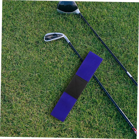 Game Changing Adjustable Golf Swing Correction Belt For Golfers Elbow Brace And Wrist Trainer on grass with clubs