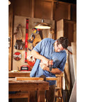 Man using V20 Cordless Drill and Driver Kit Half-Inch Brushless Motor 350 UWA Two-Speed 0-600 and 0-900 RPM in workshop