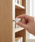 Hand inserting 200 Pack Shelf Support Pegs For Cabinets And Wardrobes White Plastic And Stainless Steel Pins For Floating Shelves