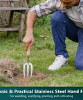 Person using stainless steel hand fork with wooden handle from 3 Piece Garden Tool Set With Stainless Steel Hand Trowel Hand Cultivator And Hand Fork With Wood Handles Perfect For Weeding Transplanting Digging And Soil Loosening Soil And Composting Includes Durable Tools For Easy Garden Upkeep And A Great Gift for gardening