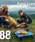 Ultralight Folding Beach Table For Camping And Picnics Portable Aluminum Side Table with food, camping gear, and campers in background