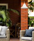 Novogratz X Globe Maxwell 11 Inch Outdoor Wall Sconce Matte White Weatherproof on brick wall in patio setting