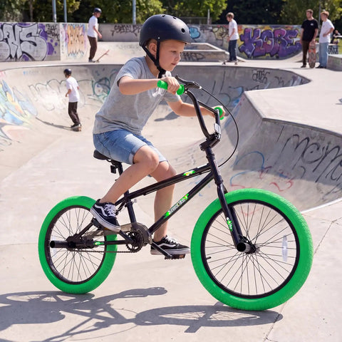 Child riding 20 Inch Freestyle BMX Bike for Beginners With 360 Degree Handlebar, 4 Pegs, U Brake, in skate park.