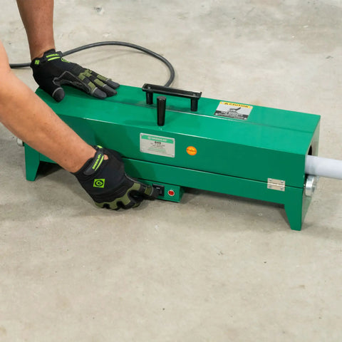 Greenlee Electric Pvc Pipe Heater For 1/2 To 2 Inch Conduit, showing operator using switch on heating unit.