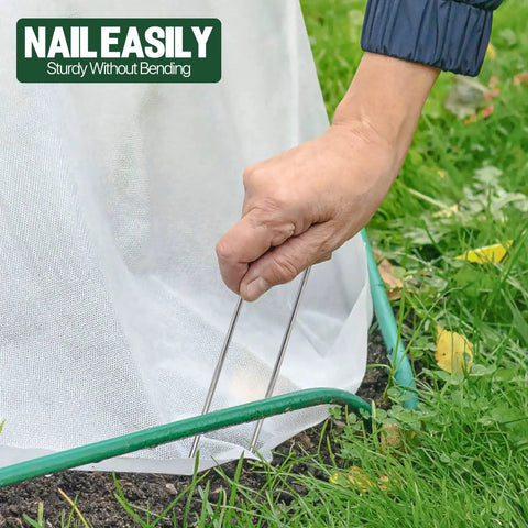 Hand installing 4 Inch Landscape Staples Pack Of 50 Galvanized Garden Stakes Anti Rust Pins For Securing Weed Barrier Fabric Artificial Turf