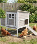 Outdoor Chicken Coop For 2-4 Chickens, Elevated 2-Tier Hen House With 3-Compartment Nest, Slide-Out Tray in a backyard with chickens