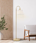 52 Inch Floor Lamp With Faux Wood Finish And White Pattern Shade Japandi Style next to armchair in modern living room.
