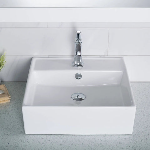 Square Vessel White Porcelain Bathroom Sink With Overflow In Eighteen And Five Eighths Inches on a countertop with faucet