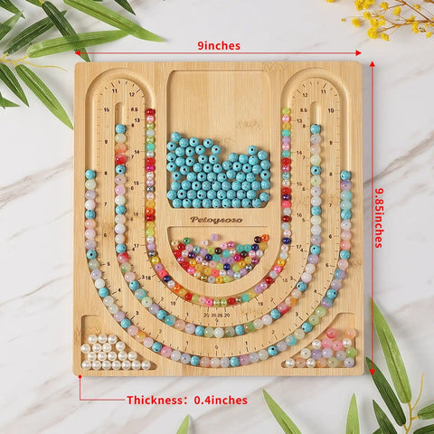 Bamboo Bead Board for Jewelry Making With 3 U Shaped Grooves And 4 Storage Slots shown with colorful beads, size markings visible.
