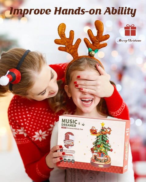 3D Puzzles For Adults Awesome Wooden Music Box Christmas Melody Tree 319 Piece Model Building Kit box held by child