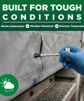 Applying industrial grade heavy duty vinyl adhesive for PVC and vinyl repairs on a tarp with a brush under tough conditions.