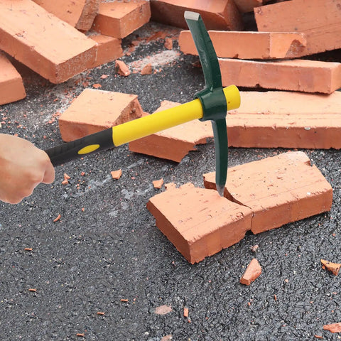Person using Three Pack 15 Inch Garden Pick Axes With Fiberglass Handles, Double Head Cast Steel Heads for breaking a brick on asphalt.
