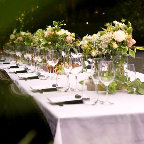 Outdoor dining with flowers on a Beefy Six Foot Folding Table With Handle Portable 330Lb Capacity HDPE Top Waterproof.