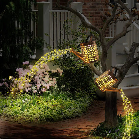 Solar Garden Watering Can With Lights hanging on tree, cascading light mimics watering flowers at night