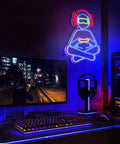 Gamer Neon Sign For Wall Decor 3D Dimmable USB Powered With 8 Modes Control transparent light up sign in a gaming setup.