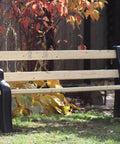 DIY Bench Ends Kit For Outdoor And Patio Benches, built with 2x4s, black finish, shown in a garden setting