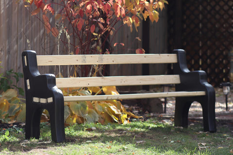 DIY Bench Ends Kit For Outdoor And Patio Benches, built with 2x4s, black finish, shown in a garden setting