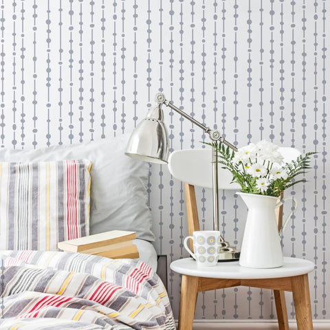 Bedroom wall with Dew Drops XL Wall Stencil 24 X 39.5 In For Large Geometric Wall Patterns visible behind a bedroom setup.
