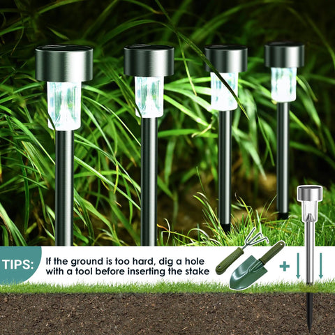 16 Pack Solar Lights Outdoor Waterproof Stainless Steel LED Garden Lights illuminating pathway beside grass