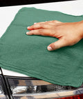 Person using Heavy Duty Shop Towels 50 Pack Green Terry Cloth Rags For Car Detailing And Home Cleaning Highly Absorbent Reusable Washable Towels For Oil Grease Spills Glass Polishing And Surfaces on car exterior