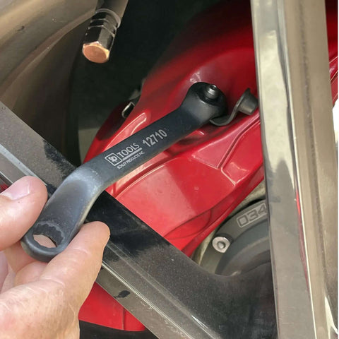 3 Piece 11mm Offset Brake Bleeder Wrench Set For Audi BMW VW Caliper Mounted Electromechanical Parking Brake Compatible No Wheel Removal Easy To Use Great For DIYers, shown being used on a red vehicle brake caliper