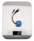 LE2204 1800KV Brushless Motor for RC Plane 2 to 3S LiPo weighing 27 grams with 3.5mm banana plug adapters shown on a scale
