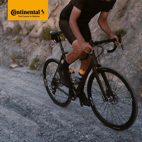 Cyclist riding off-road with Cross 28 Butyl Cyclocross Bike Inner Tubes Pair For 700C Wheels 32-47c With 60mm Presta Valve Deep Rim