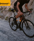 Cyclist riding a road bike on gravel, showcasing Continental tires; Premium Inner Tubes 700x32-47 (28x1.5-1.75) 42mm Presta Valve Pack Of 2 Fits 32-622 To 47-622 Durable Seamless Vulcanized, Quality Tested For Road Bike Wheels.