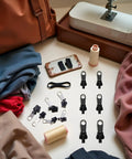 GoTo 12-Piece Black Zipper Puller Repair Kit With Detachable Sliders for Jackets, Coats, Luggage, Backpacks, and Bags displayed on sewing table
