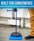 Man using Beefy Heavy Duty 10 Inch Cable Reel Dispenser Stand With Non Slip Feet Portable Drum Holder in workshop