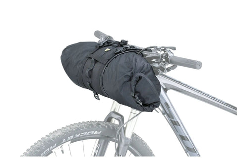 FrontLoader 8L Waterproof Handlebar Bag For Bikepacking And Camping mounted on a bicycle with quick release straps and external gear strap.