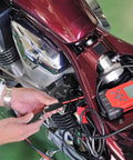 Person using Beefy 2 Pack 2 Pin Quick Disconnect Polarized SAE Wire Harness on motorcycle for battery charging
