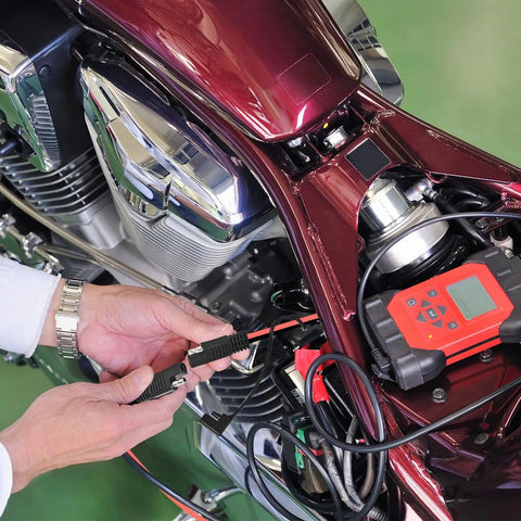Person using Beefy 2 Pack 2 Pin Quick Disconnect Polarized SAE Wire Harness on motorcycle for battery charging
