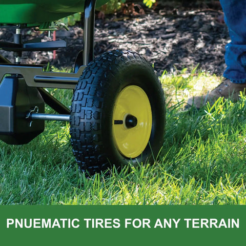 Push Broadcast Spreader With 130 Lb Capacity And Rust Proof Poly Hopper tire detail in grass