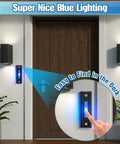 Lighted Doorbell Button for Wall Mount and Garage Door Switch With Blue LED No Fuss Install Works With Most Wired Door Chimes Transformers Ringers Buzzers Black Finish 1 Pack installed on a door with blue lighting.