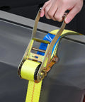 Heavy Duty Badass Ratchet Straps 4 Pack 2 Inch Wide By 27 Feet Long With Double J Hooks tightening cargo in a truck bed.