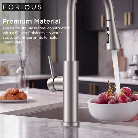 FORIOUS Kitchen Faucet with Pull Down Sprayer, High Arc, Brushed Nickel pouring water over grapes in kitchen.