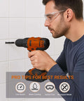 Cordless drill with glass-tile drill bit in use by man wearing safety glasses, side view against white tiles.