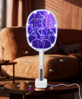 3 Pack Electric Fly Swatter Rackets For Home And Outdoor Use. High voltage bug zapper on table, ideal for mosquito control.