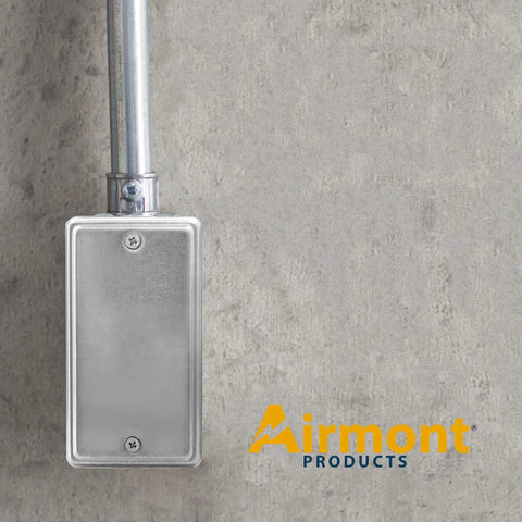 No Nonsense Utility Electrical Junction Box And Blank Cover Combo Gritty Galvanized Steel Drawn Body on a concrete wall.