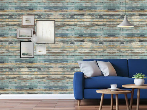 Living room with blue distressed wood grain peel and stick wallpaper for cabinets and walls, couch and decor.