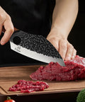 Hand Forged Meat Cleaver With Leather Sheath For Everyday Kitchen Prep cutting meat on wooden board
