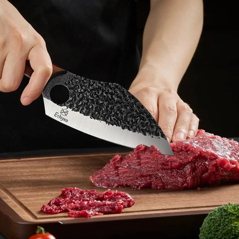 Hand Forged Meat Cleaver With Leather Sheath For Everyday Kitchen Prep cutting meat on wooden board