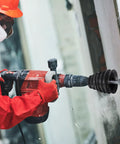 5 Pack Top Shelf Heavy Duty Silicone Drill Dust Collectors For Electric Hammer And Impact Drills Black in action with dust collection.